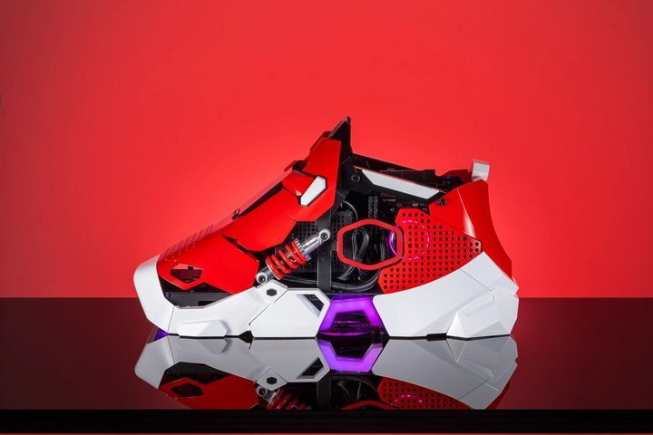 The Cooler Master CMODX Sneaker X PC against a red background.