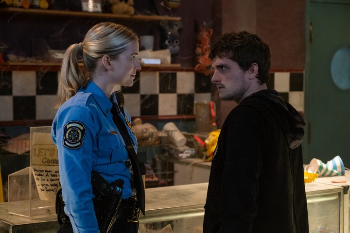 Elizabeth Lail and Josh Hutcherson face each other in Five Nights at Freddy's.