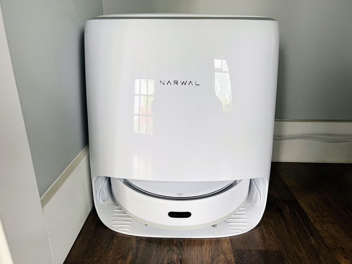 The base station for a Narwal robot vacuum and mop sits in a corner.
