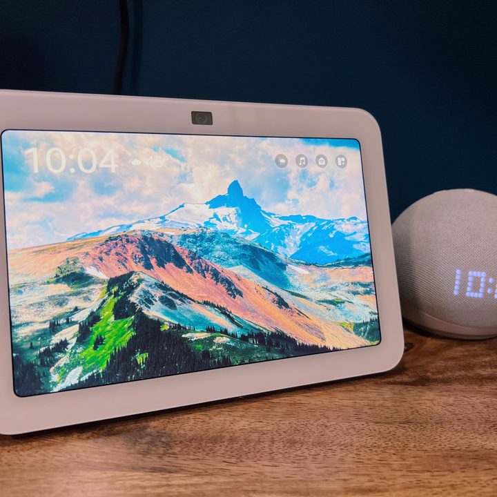The Amazon Echo Show 8 sits next to an Echo Dot for scale.