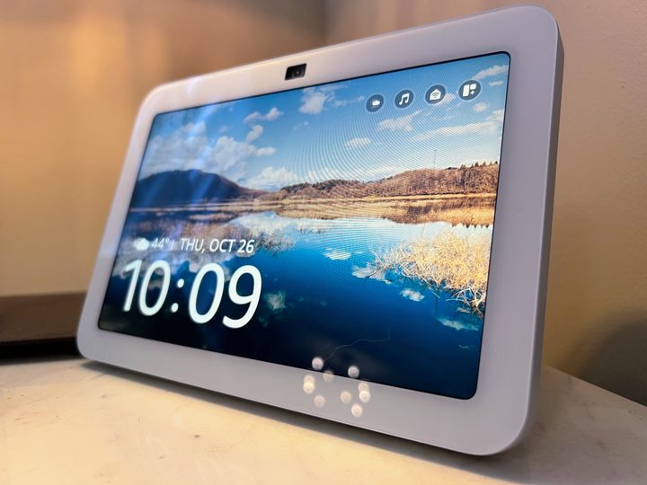An Amazon Echo Show 8 sits on a marble side table.