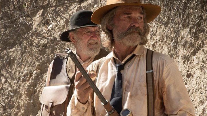 Kurt Russell and Richard Jenkins as Franklin Hunt and Deputy Chicory in a desert looking in the same direction in the film Bone Tomahawk.