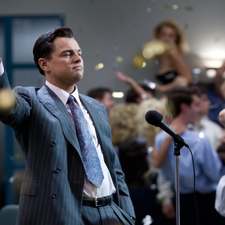Leonardo DiCaprio stands near a microphone in The Wolf of Wall Street.