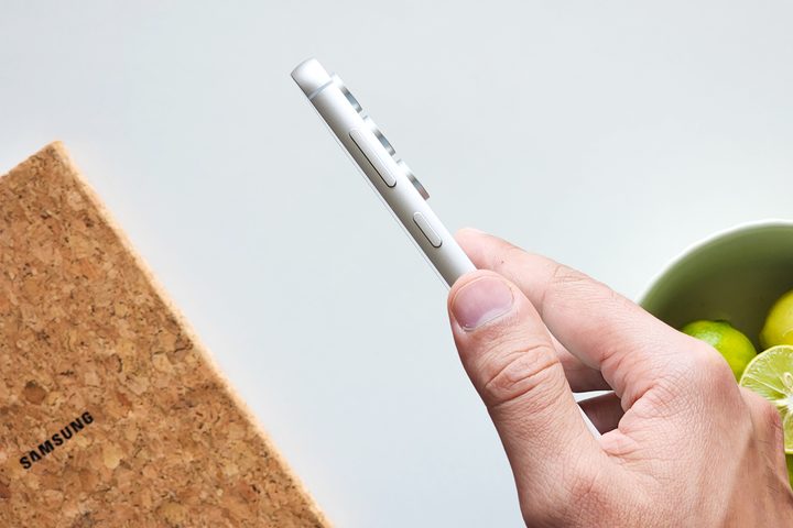 Samsung Galaxy S23 FE Mint Green held from the side showing the aluminum frame.