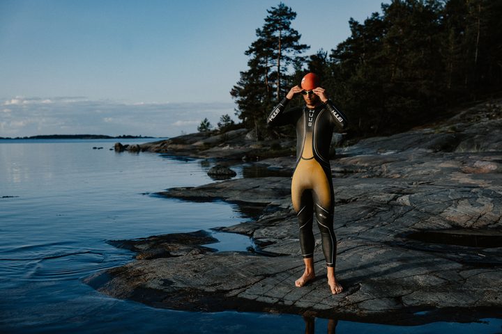 A swimmer on the side of water wearing a Polar Vantage V3.