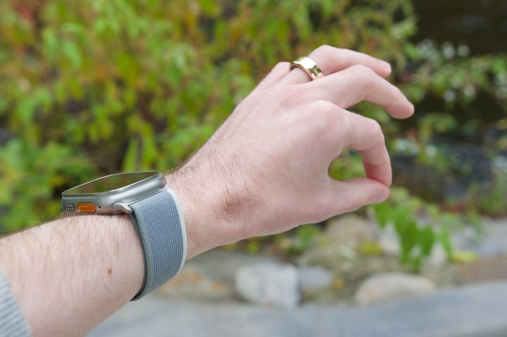 A photo of someone gesturing with their hand to use Double Tap on the Apple Watch Ultra 2.
