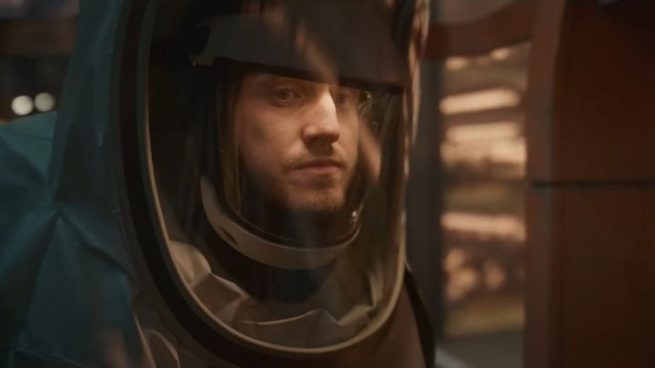 A man wears a space suit in Foe.