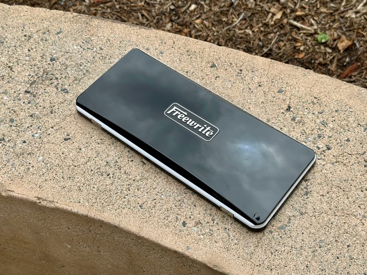Freewrite Traveler closed on a concrete bench.