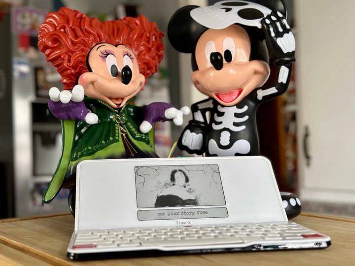 Freewrite Traveler open on screensaver with Disney Halloween figures.