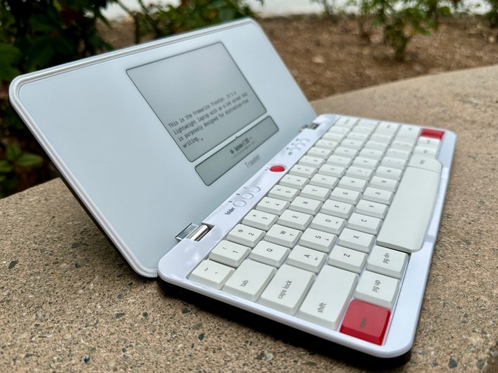 Freewrite Traveler open on a bench angled slightly.