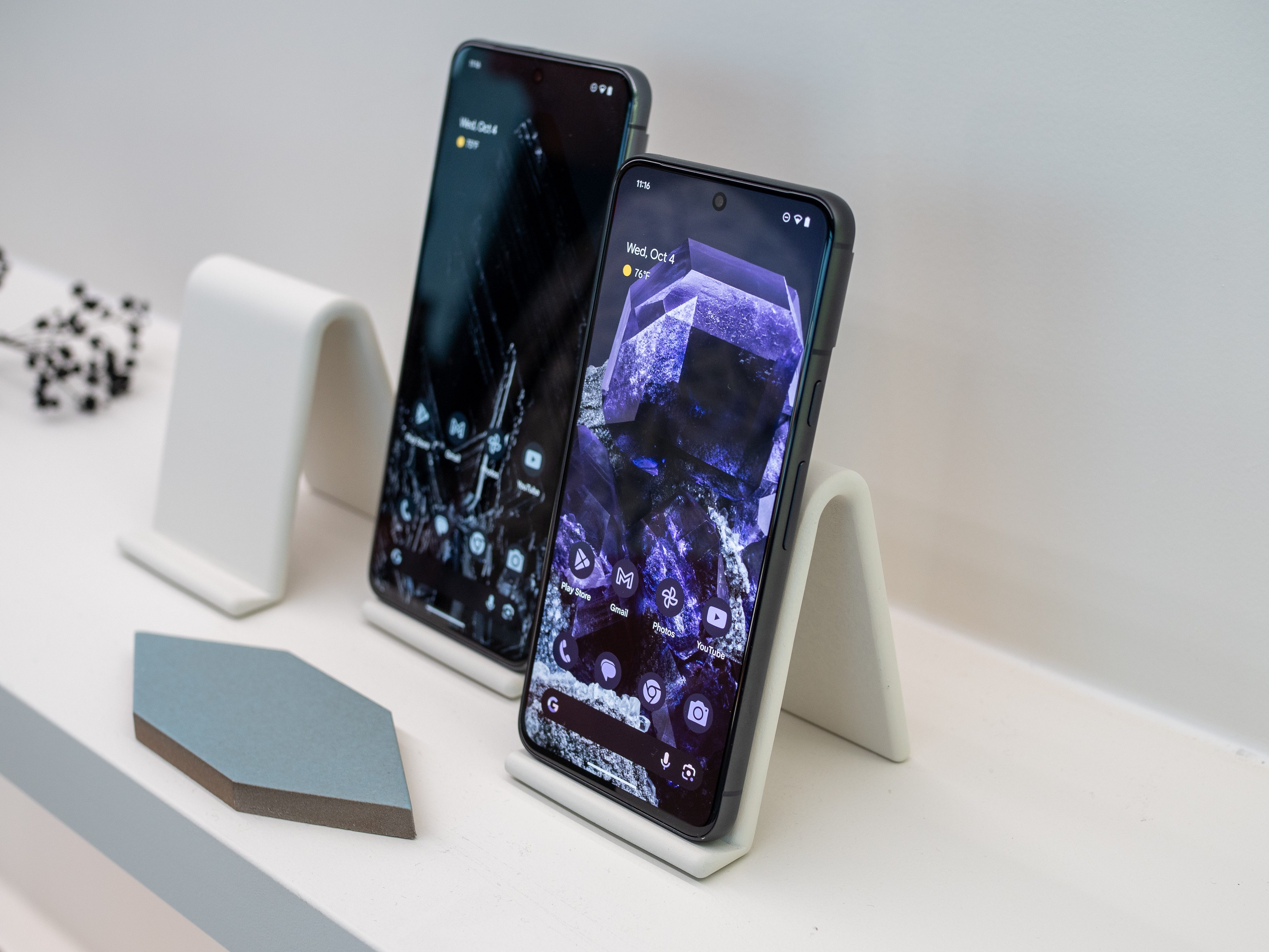 Google Pixel 8 in black, with the screen on.