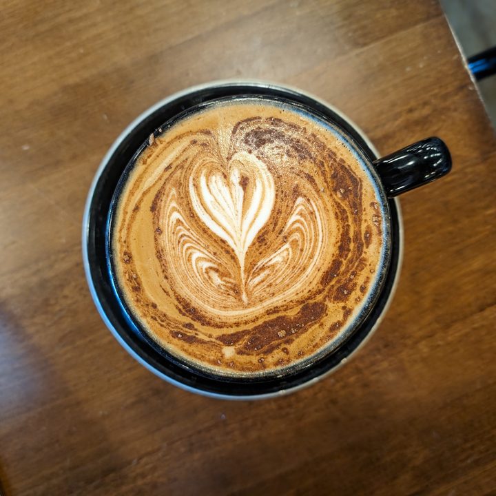 Photo of a hot coffee with a heart design on top, taken with the Google Pixel 8 Pro.