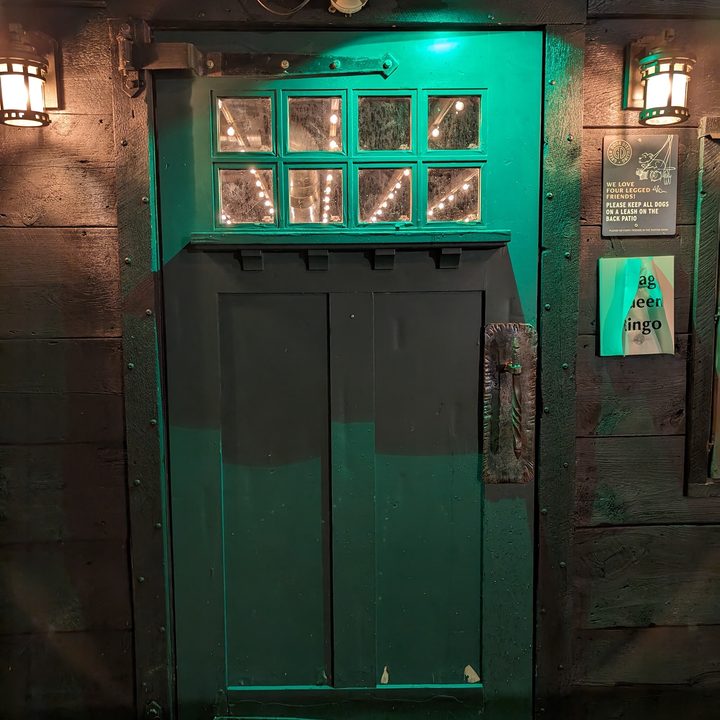 Photo of a green door late at night, taken with the Google Pixel 8 Pro.