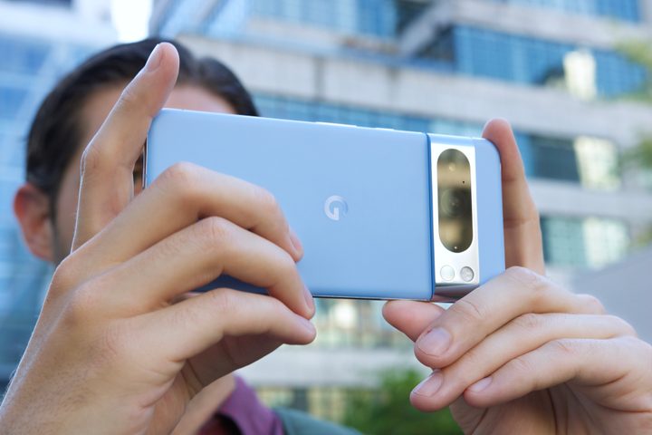 Someone taking a photo with the Google Pixel 8 Pro in a landscape orientation.