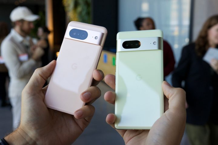 The Google Pixel 8 and Google Pixel 7 being held next to each other.