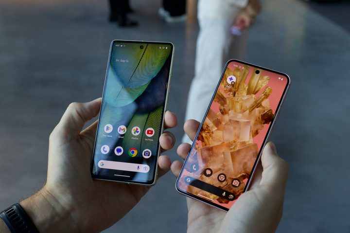 The Google Pixel 8 and Google Pixel 7 being held next to each other.