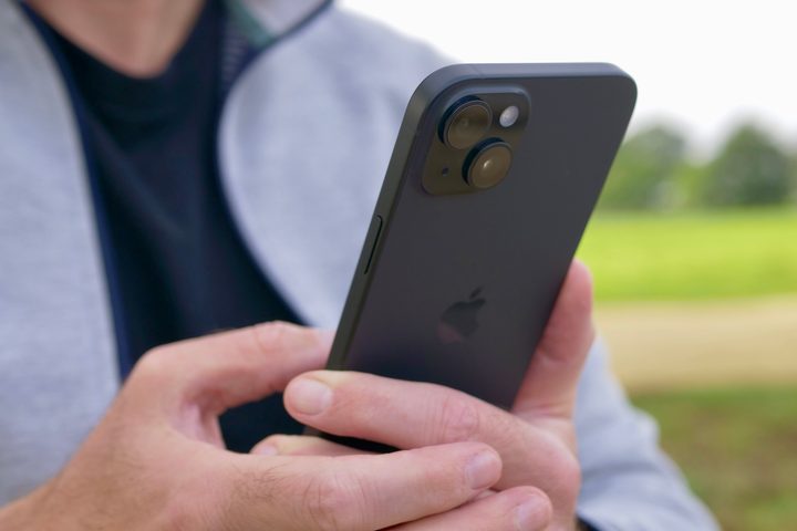 A person holding the Apple iPhone 15 Plus, showing the camera.