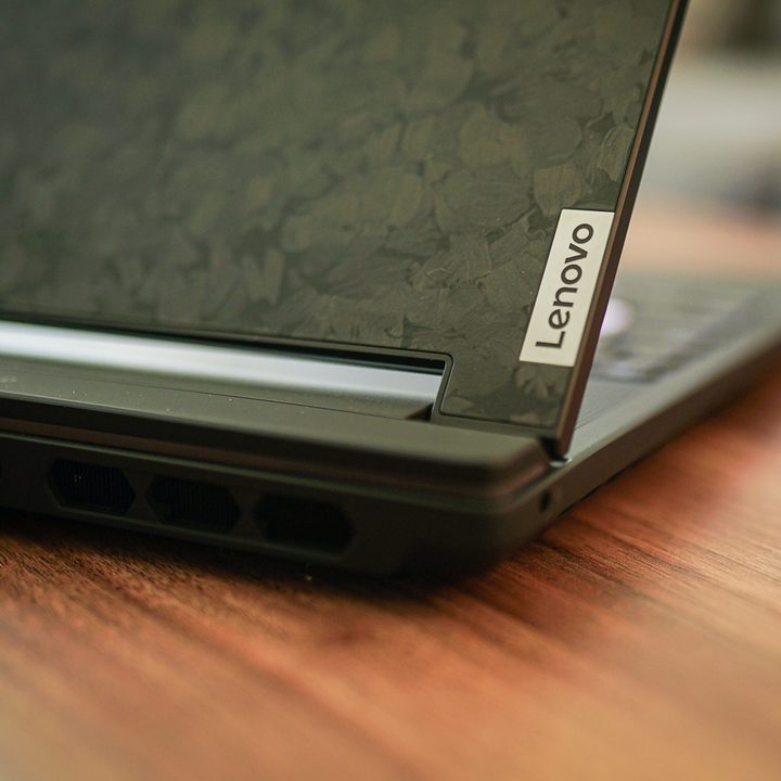 A closeup of the Lenovo logo on the lid of a laptop.