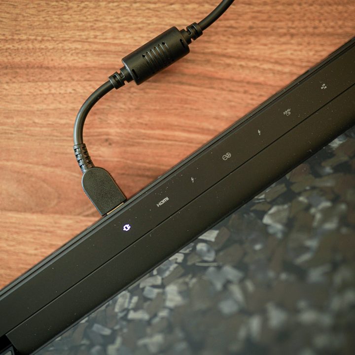 The charger plugged into the Lenovo Legion 9i.
