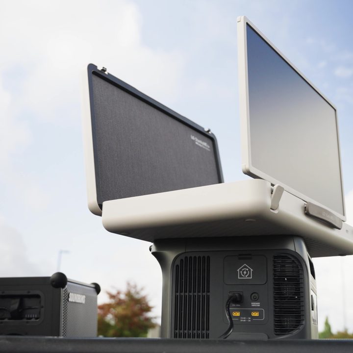 An LG StanbyMe Go briefcase TV open and propped on top of an external battery supply.