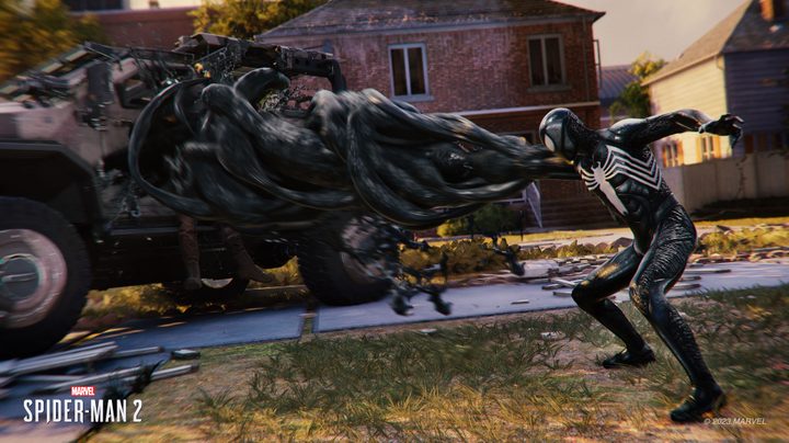 Peter Parker grabs a car with his Symbiote suit in Marvel's Spider-Man 2.