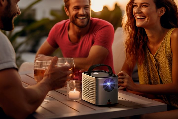The Nebula Mars 3 Air portable projector on a coffee table outdoors.