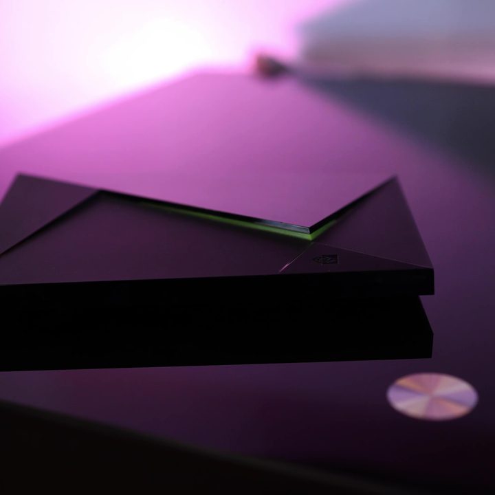 An Nvidia Shield on a table with purple back light.
