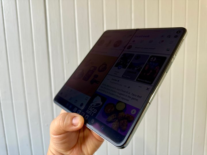 OnePlus Open in Emerald Dusk open with screen dimmed at an angle to see crease.