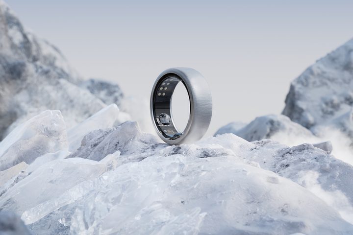The Oura Ring in brushed titanium sitting on ice.