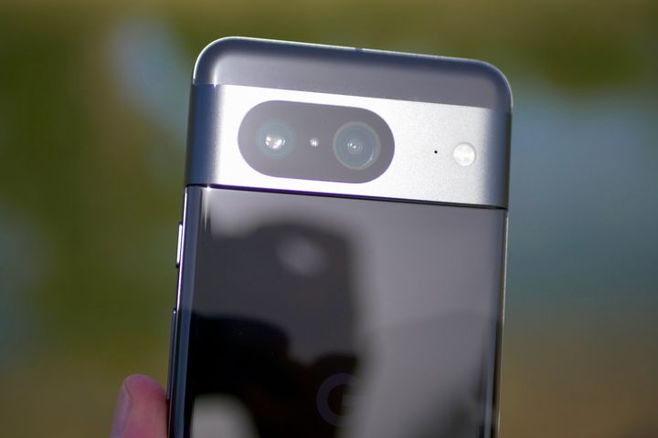 A person holding the Google Pixel 8, showing the camera module.