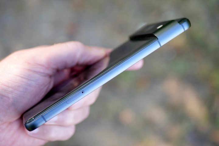 A person holding the Google Pixel 8, showing the side.