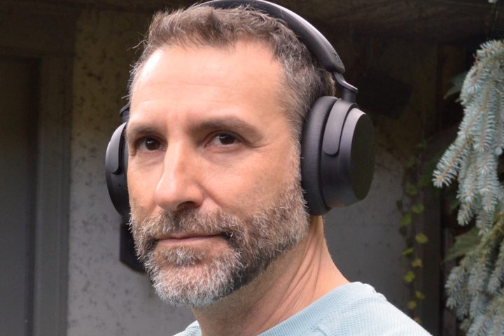 Simon Cohen wearing Sennheiser Accentum Wireless headphones.