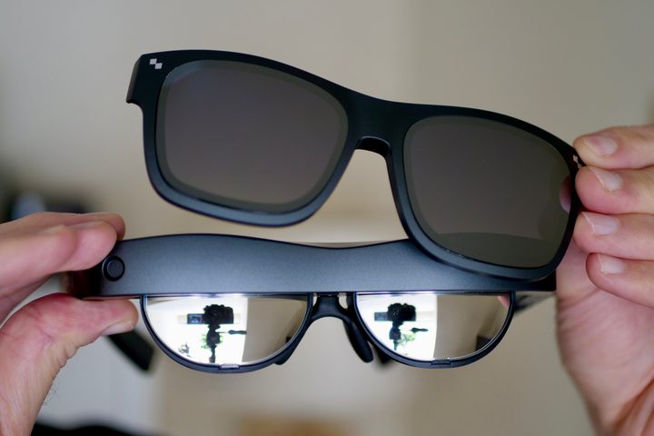 Taking off the TCL RayNeo Nxtwear S XR glasses's sunglass attachment.