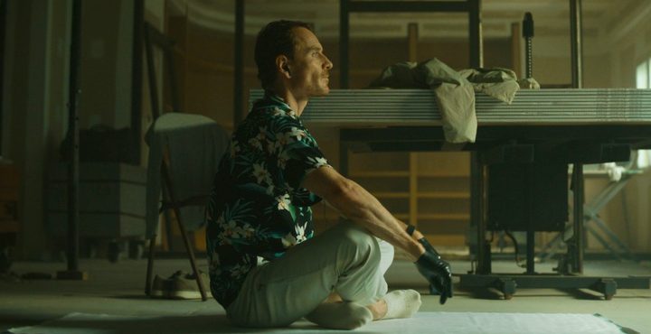 A man sits on a floor in The Killer.