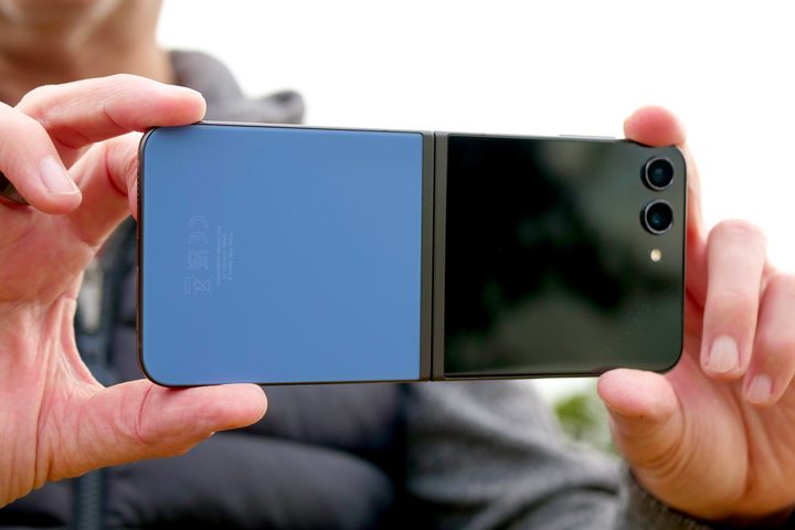 A person taking photos with the Samsung Galaxy Z Flip 5.