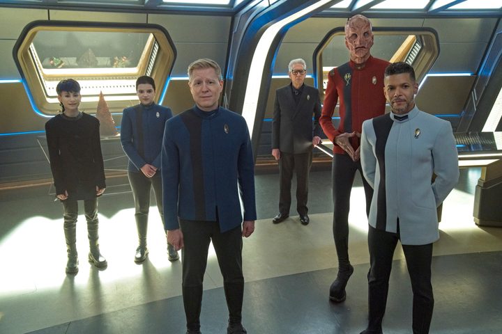 Gray, Adira, Stamets, Kovich, Saru, and Culber stand in the Discovery ready room, facing us.