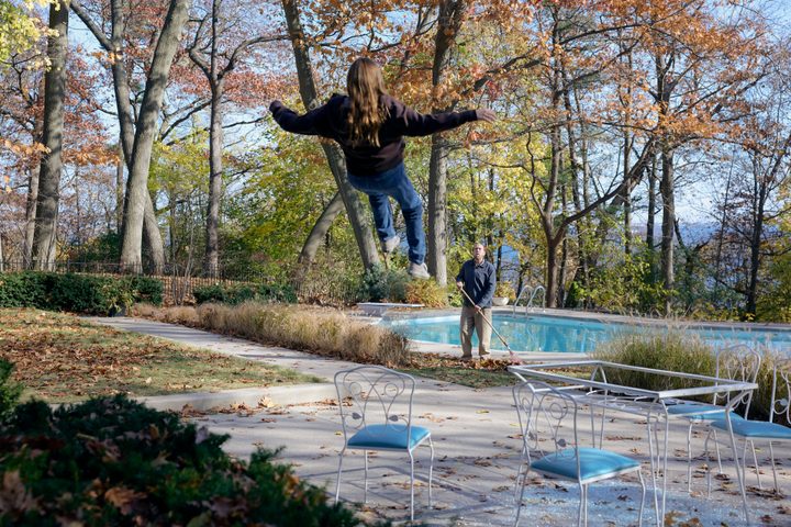 A girl floats near Nicolas Cage in Dream Scenario.