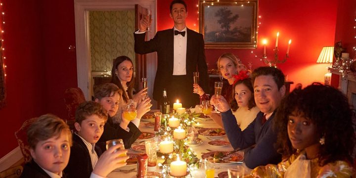 A group sits at a table hosting a party in Silent Night