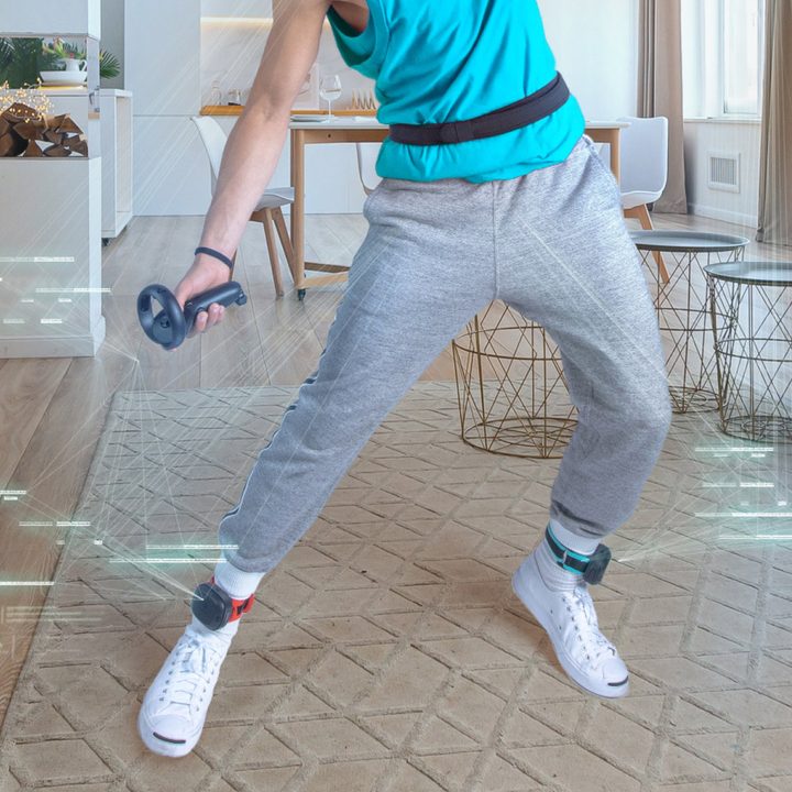 A lower body shot of a person wearing HTC VIive Ultimate Trackers with TrackStraps.