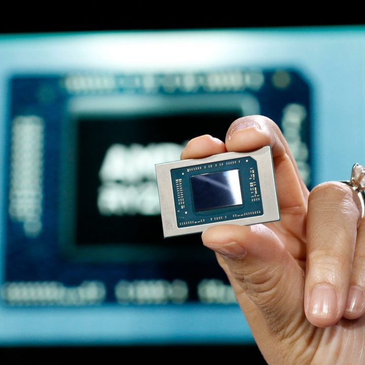 AMD CEO Lisa Su holding an APU chip.