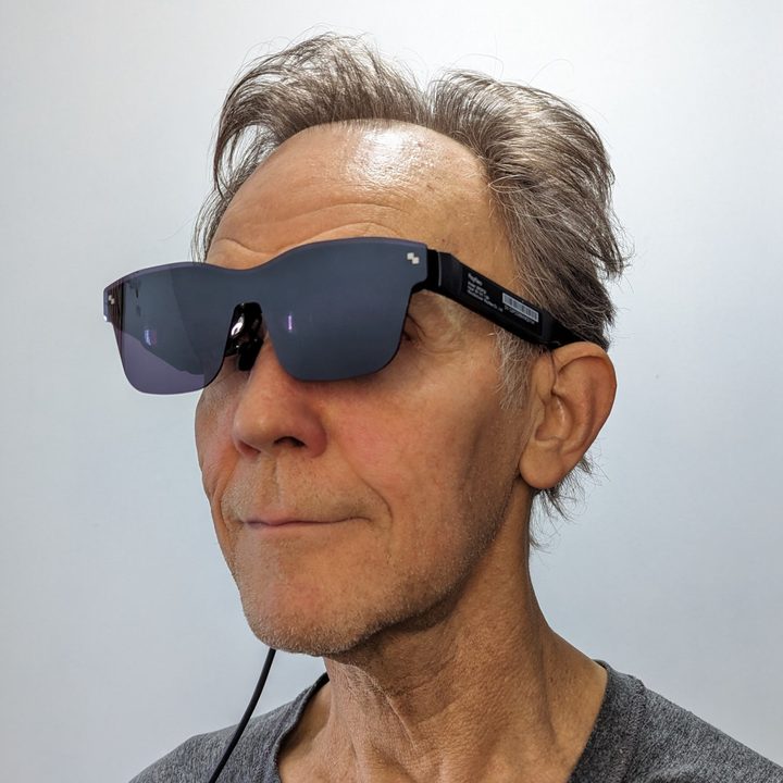 Alan Truly wears the TCL RayNeo Air 2 smart glasses.
