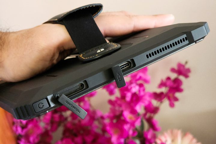 Rubber flaps covering the ports on Man holds Blackview Active 8 Pro rugged Android tablet.