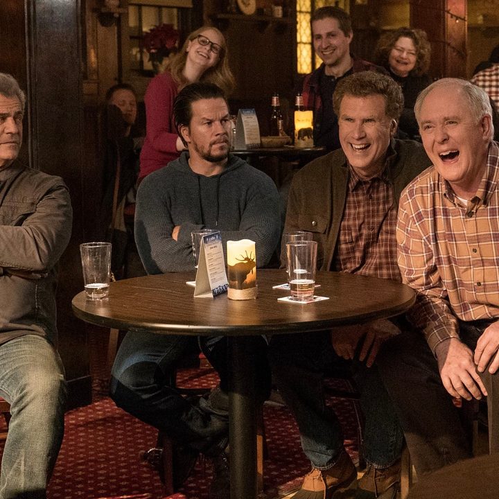 Four men sit at a table and laugh in Daddy's Home 2.