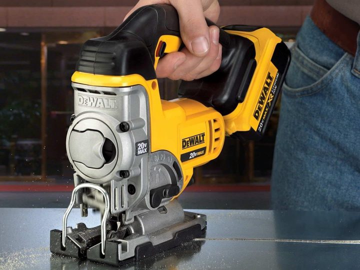 A man using a 20V DeWalt Jigsaw.