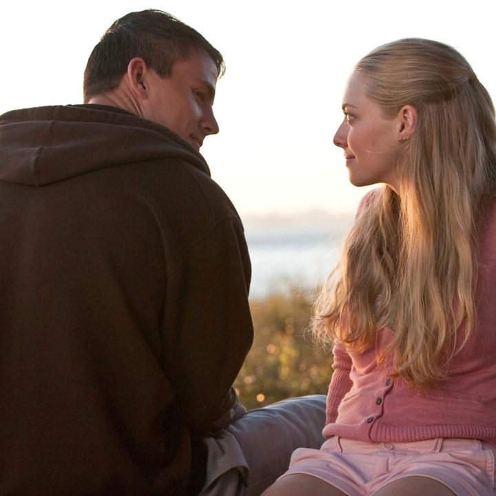 A man and woman sit next to each other.