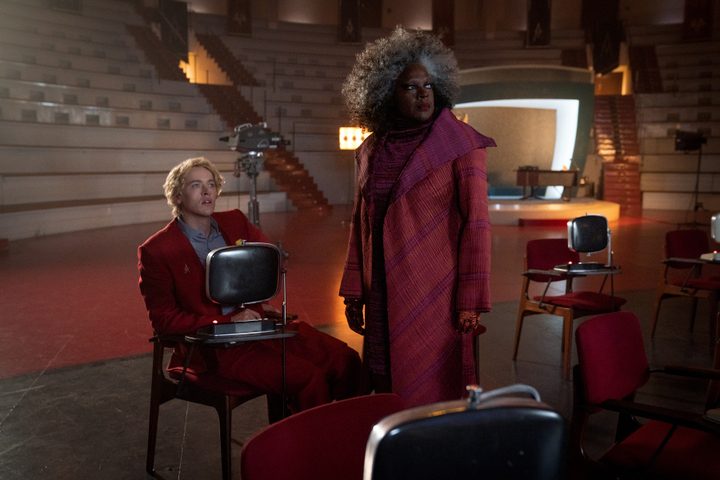 Dr. Gaul stands near Coriolanus Snow in The Hunger Games: The Ballad of Songbirds & Snakes.