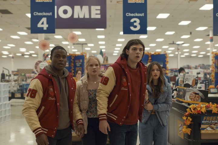 Four teenagers stand in a store together in Thanksgiving.