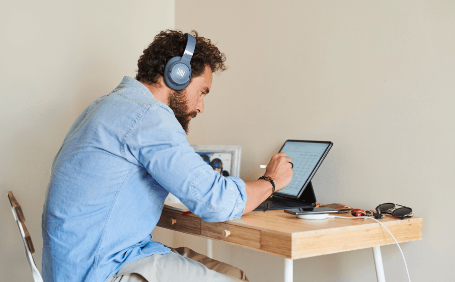 The JBL Tune 760NC wireless headphones on someone's head.