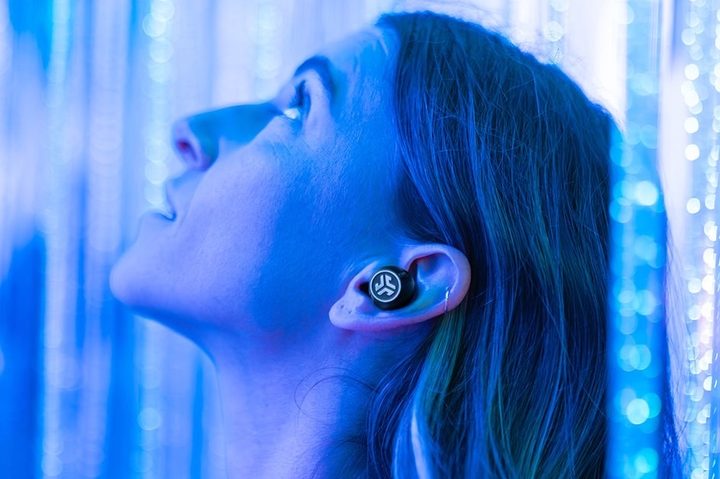 Woman wearing JLab Epic Lab Edition wireless earbuds.