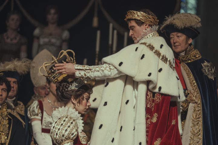 Joaquin Phoenix crowns Vanessa Kirby in Napoleon.